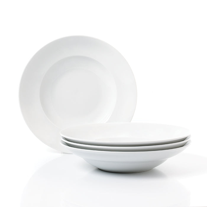 A set of four large white porcelain pasta bowls stacked in a pyramid shape with a plain white plate on top.