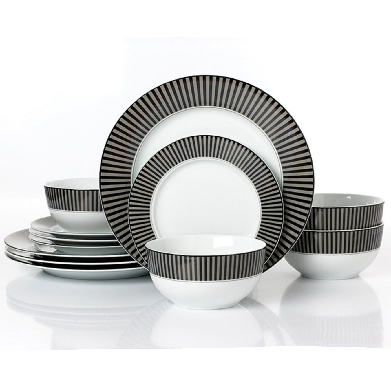 Set of black and white striped dinnerware on a white background