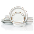 Set of white dinnerware with gold rim on a white background