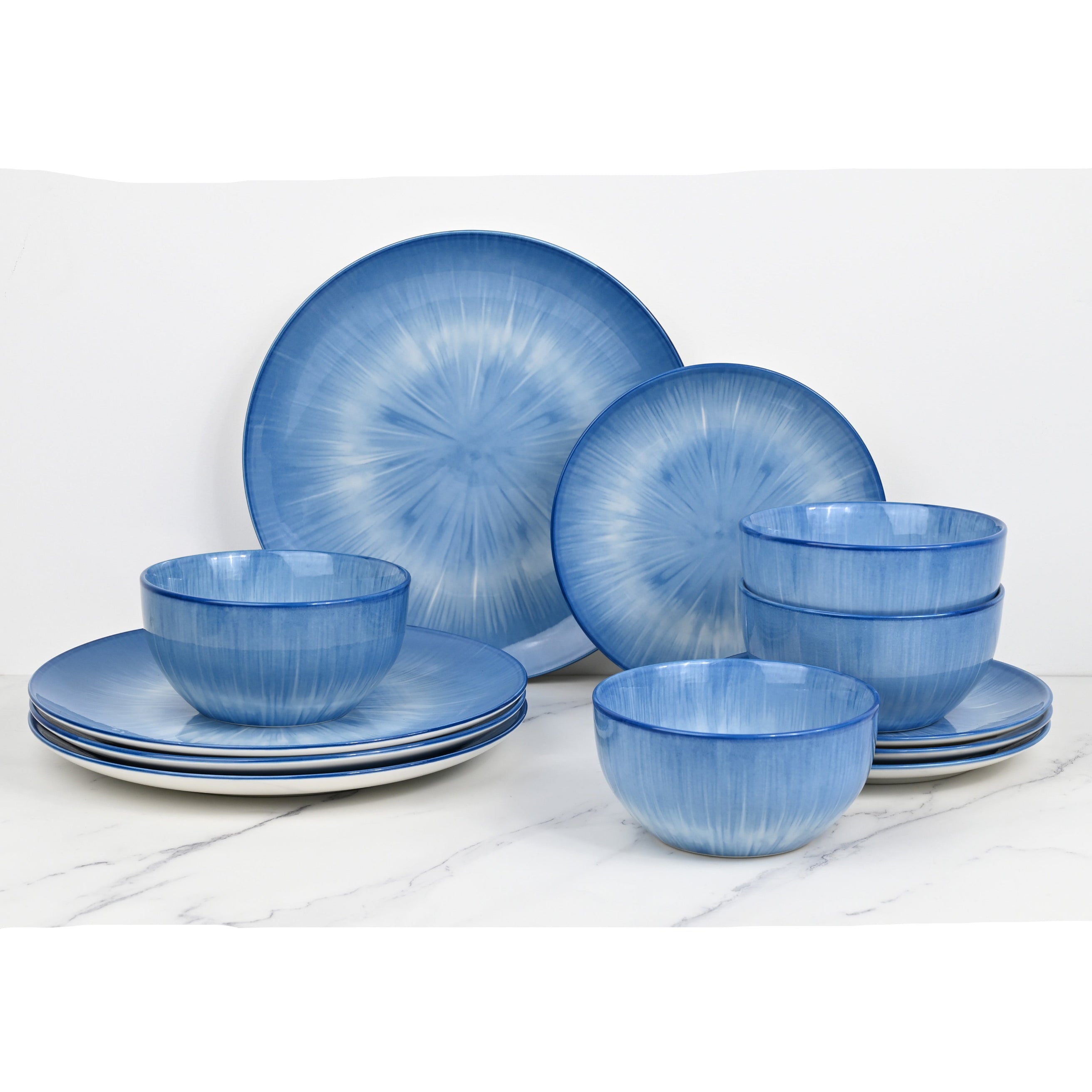 Set of blue ceramic dinnerware on a white surface