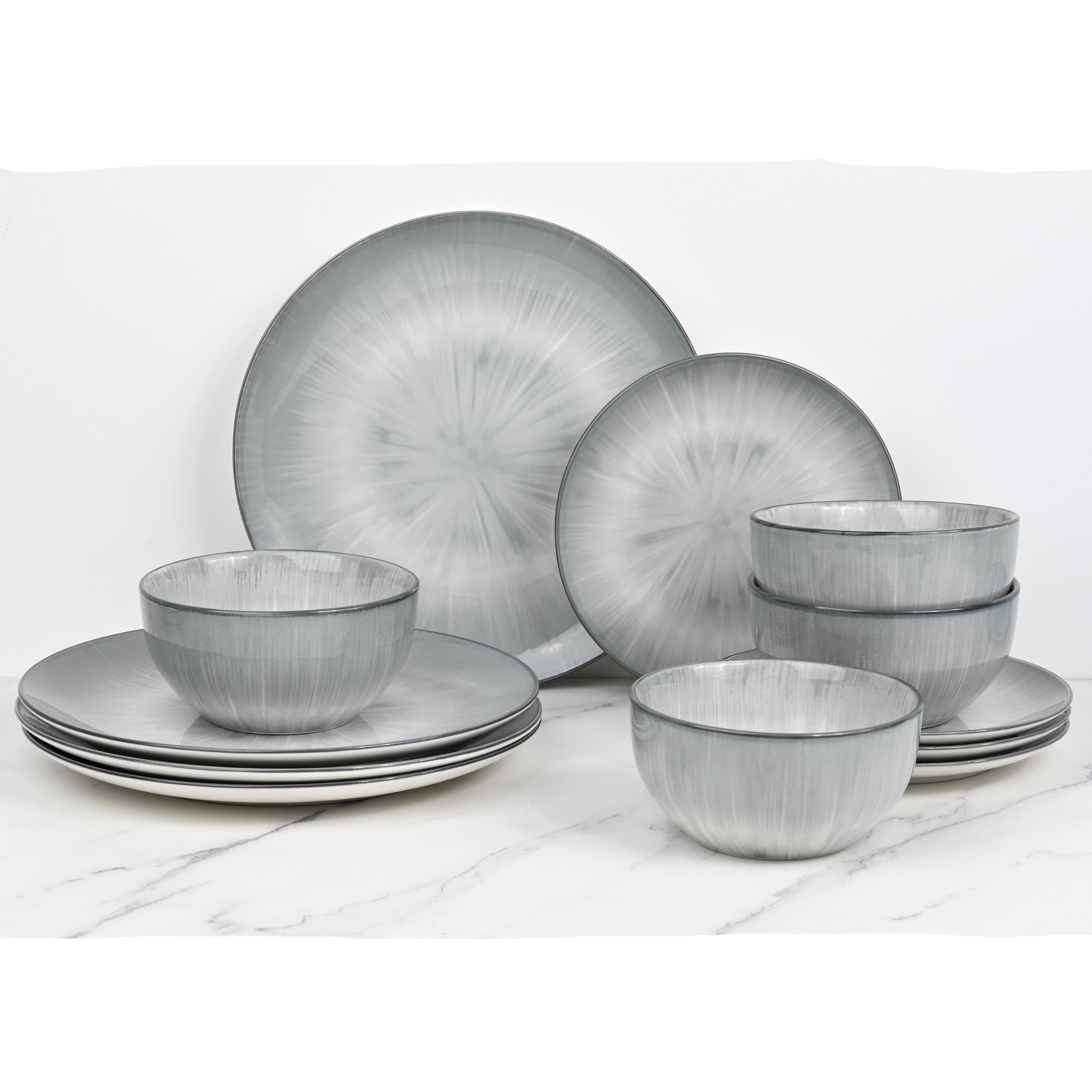 Set of gray ceramic dinnerware on a white surface